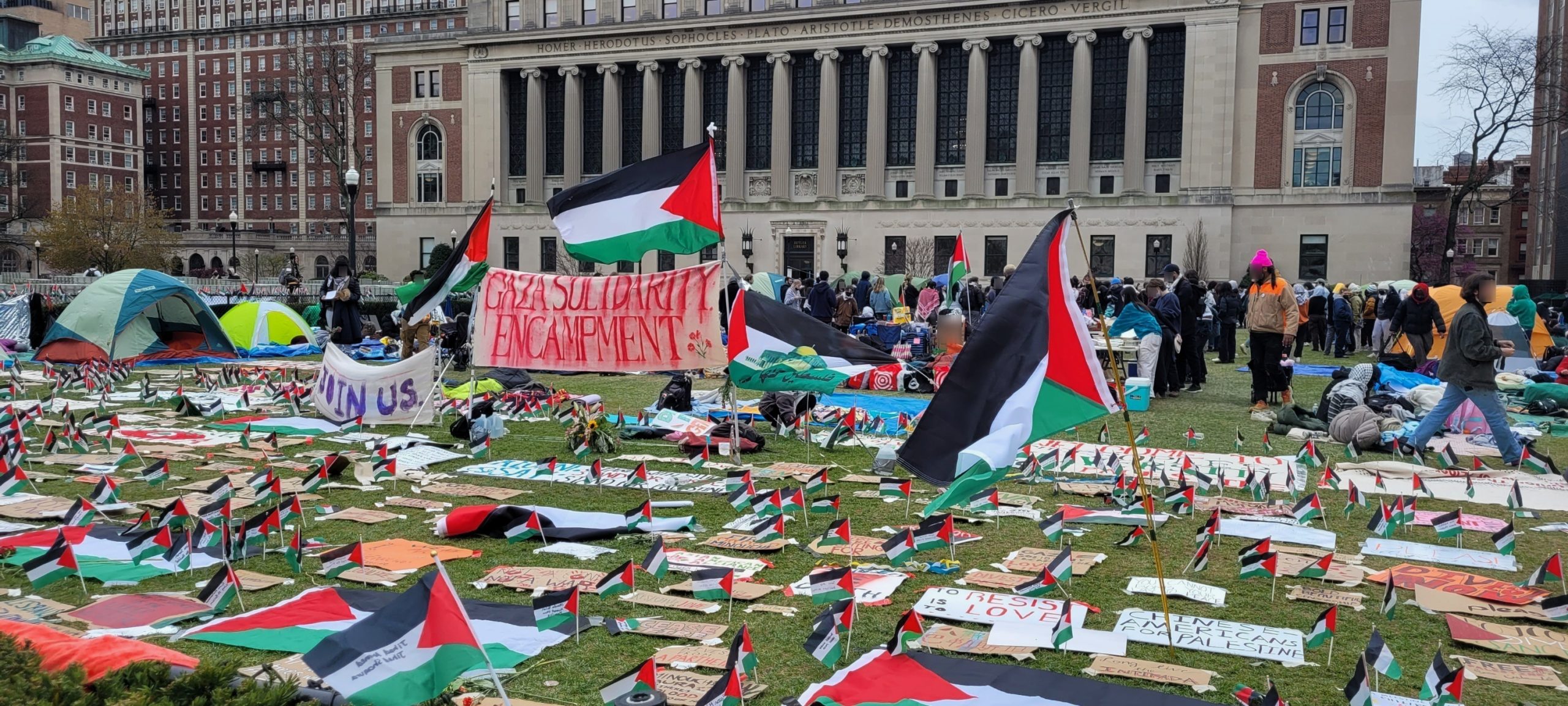 palestinian flags and signs on lawn of columbia campus